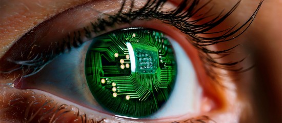 Close-up of an eye with a green circuit-board pattern reflected in the iris, blending biology and tech.